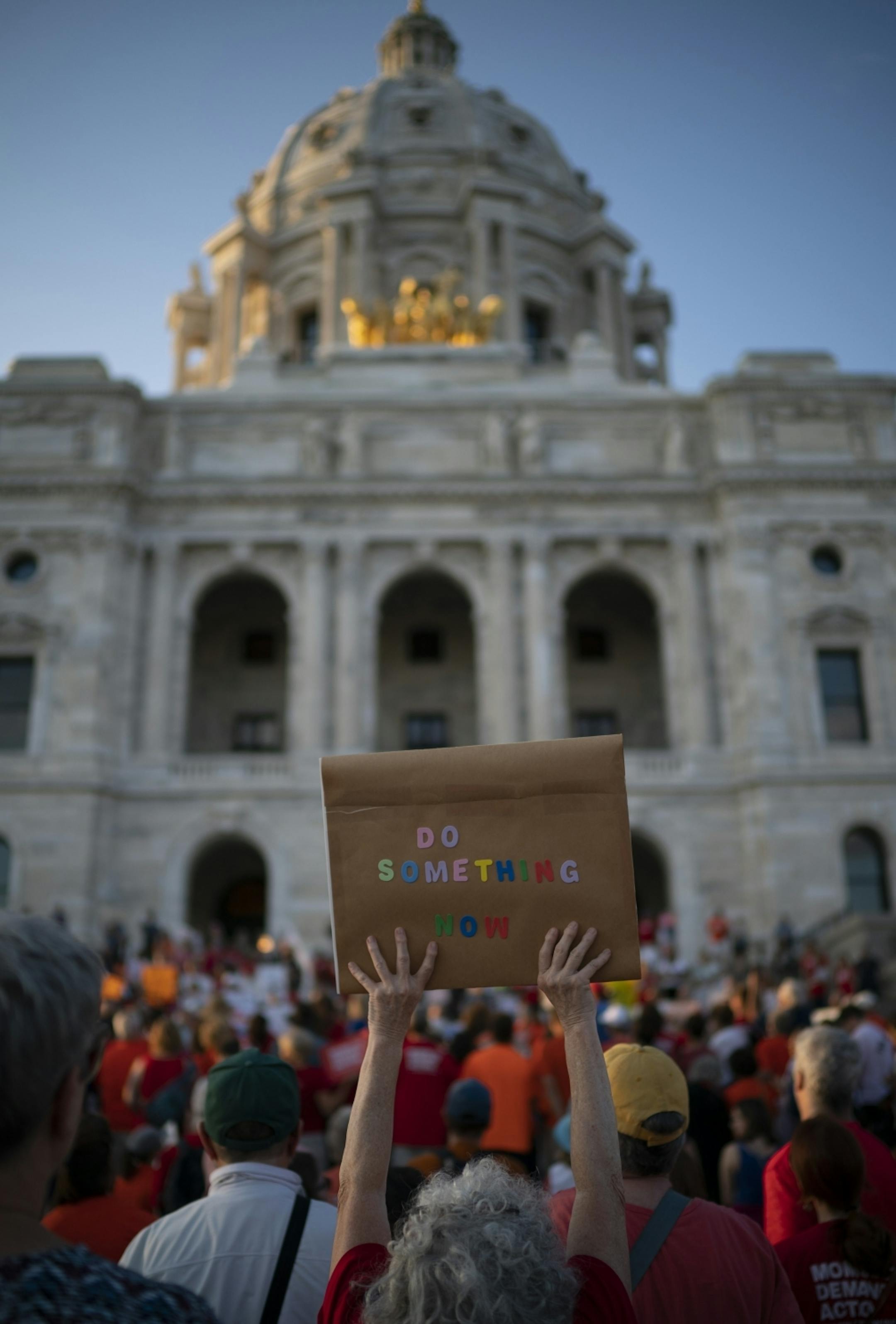 A handmade sign was held up while listening to speakers at the rally. In addition to background checks, speakers called for a ban on assault rifles and red-flag laws
