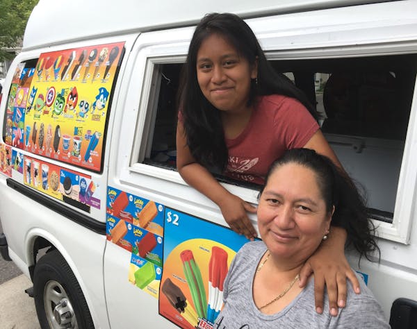Gina, left, and her mom, Rosa Chunchi, with their cold-treat truck that was vandalized by a stranger at a Minneapolis park.
