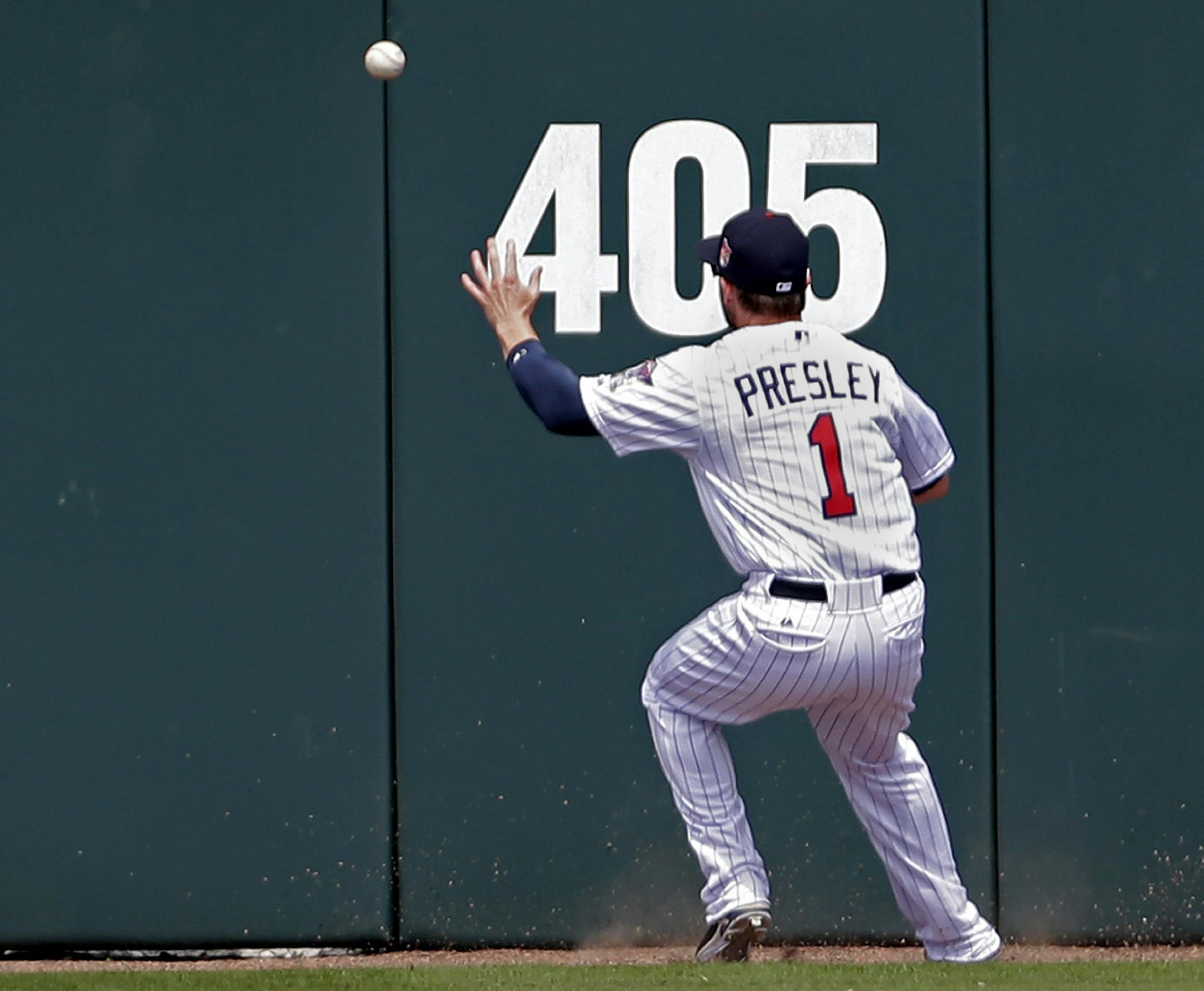 Minnesota Twins center fielder Alex Presley (1) tries to corral a double to center by Pittsburgh Pirates Jaff Decker during the third inning of an exhibition baseball game in Fort Myers, Fla., Wednesday, March 12, 2014. (AP Photo/Gerald Herbert)