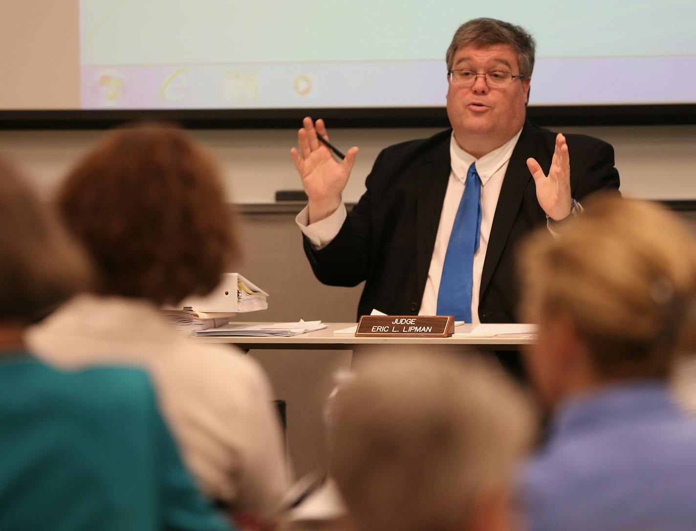 Judge Eric Lipman presided over a Minnesota Department of Health hearing on a new state rule that would expand the number of shots Minnesota kids are supposed to get before kindergarten. Around fifty people attended the hearing on 6/27/13. The state Department of Health says the new guidelines merely bring Minnesota into line with recommendations of the American Academy of Pediatrics and general practive of most Minnesota doctors. Fretful parents say vaccines have terrible side-effects that the