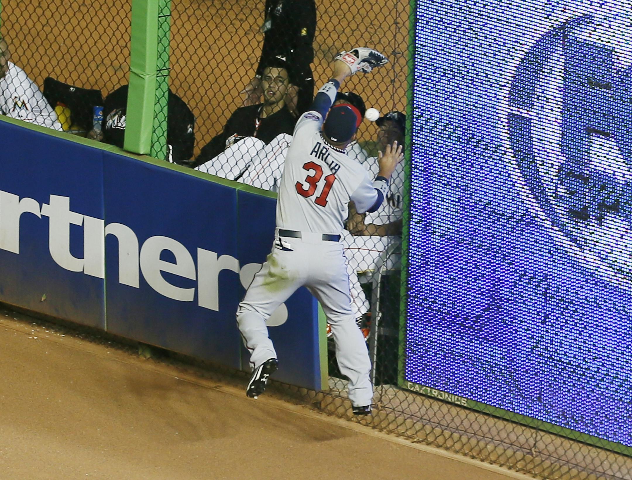 Twins right fielder Oswaldo Arcia couldn't grab this fly ball hit by the Marlins' Giancarlo Stanton during the first inning. Arcia later contributed a single in the Twins' eighth-inning rally that fell short.