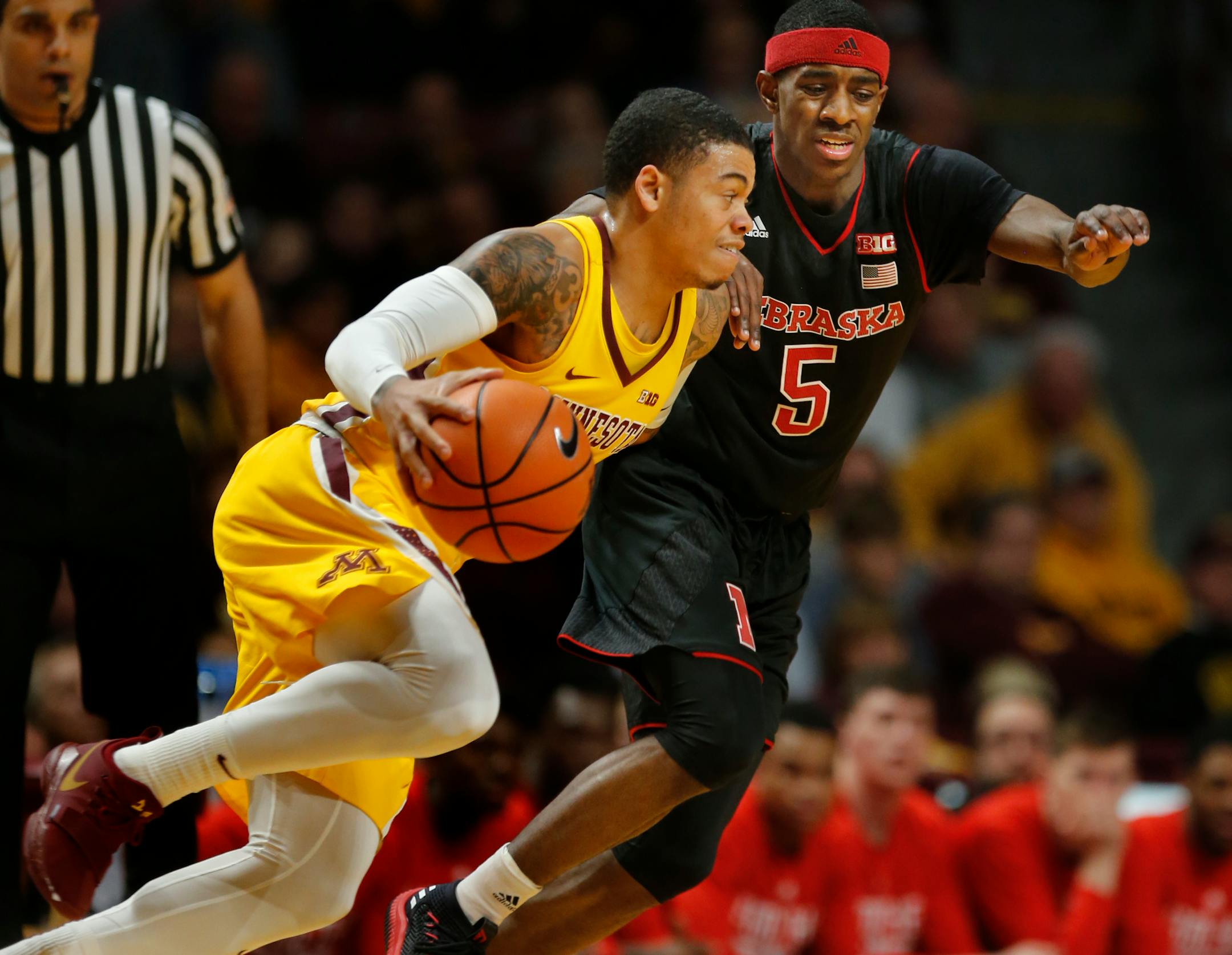 Nate Mason drove against Glynn Watson Jr. of Nebraska.