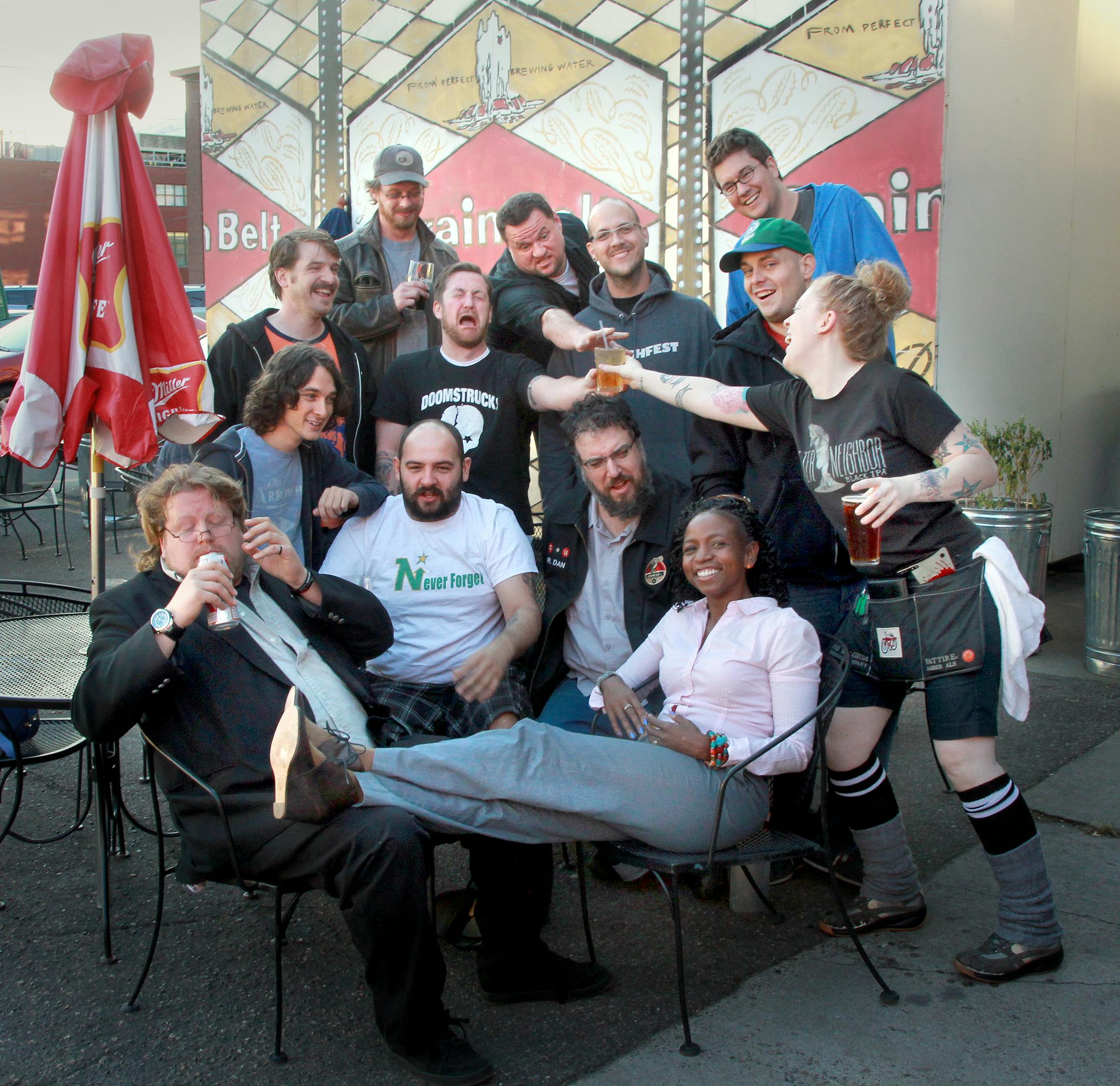 On the outdoor patio a group a of comics gather for a groupshot. From left, front row, Andy Brynildson, Shannan Paul, second row from left, Derek Henkels, Corey Adam, Dan Schlissel, third row, Zach Coulter, Chris Maddock, Mike Brody, Erik Allen, Back row, Jason Kruger, Gus Lynch and in Blue sweatshirt, Bryan Miller. The waitress delivering drinks is Tiffany Roberts of Grumpy�\u20ACTMs Bar & Grill on Washington. [ TOM WALLACE �\u20AC� twallace@startribune.com _ Assignments #20025632A_ 0ctober 1,