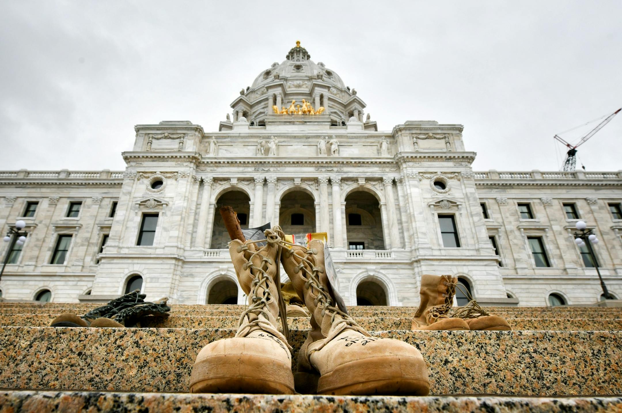 Family members of Joel Costa, a Minnesota National guardsman who committed suicide February 12, 2017, brought his boots Monday morning to be part of the week-long commemoration.