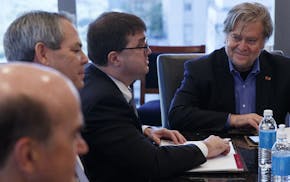 Steve Bannon, campaign CEO for Republican presidential candidate Donald Trump, right, looks on during a national security meeting with advisors at Tru