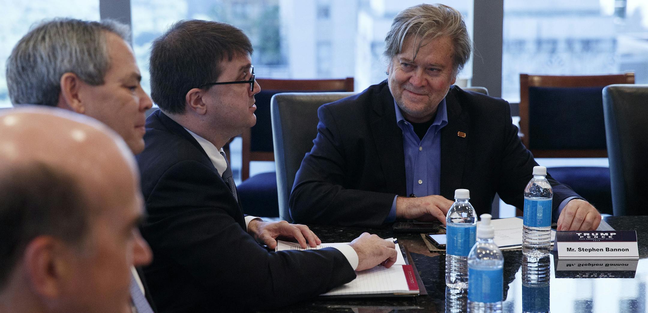 Steve Bannon, campaign CEO for Republican presidential candidate Donald Trump, right, looks on during a national security meeting with advisors at Trump Tower, Friday, Oct. 7, 2016, in New York. (AP Photo/ Evan Vucci) ORG XMIT: MIN2016111513025126