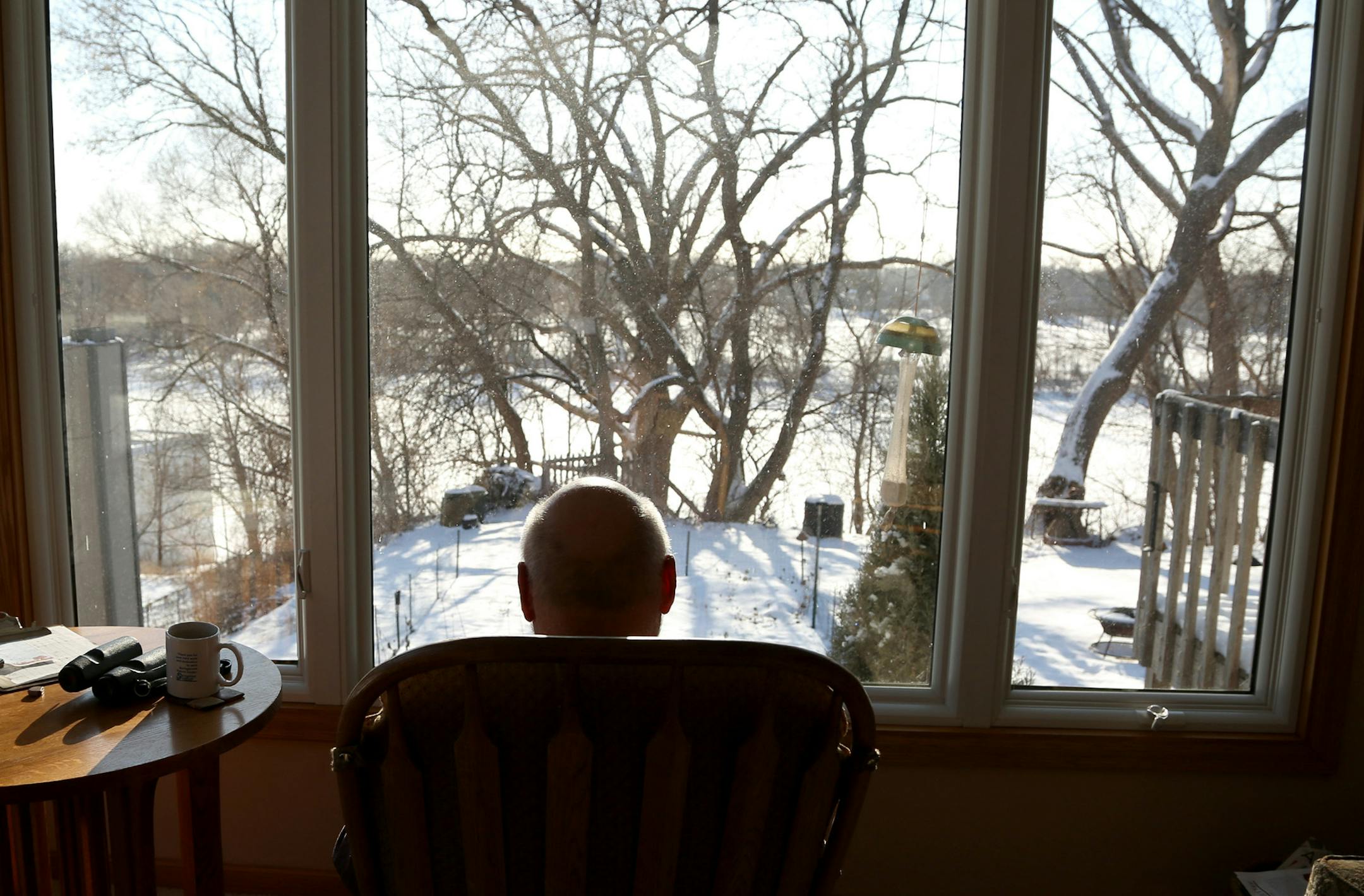 Jerry Bahls sat in his chair where he identified birds in his back yard. Balls was helping find solutions to the Vikings stadium glass and the safety of birds. ] (KYNDELL HARKNESS/STAR TRIBUNE) kyndell.harkness@startribune.com Bahls' home in Fridley, Min., Tuesday, March 3, 2015. ORG XMIT: MIN1503031718230512