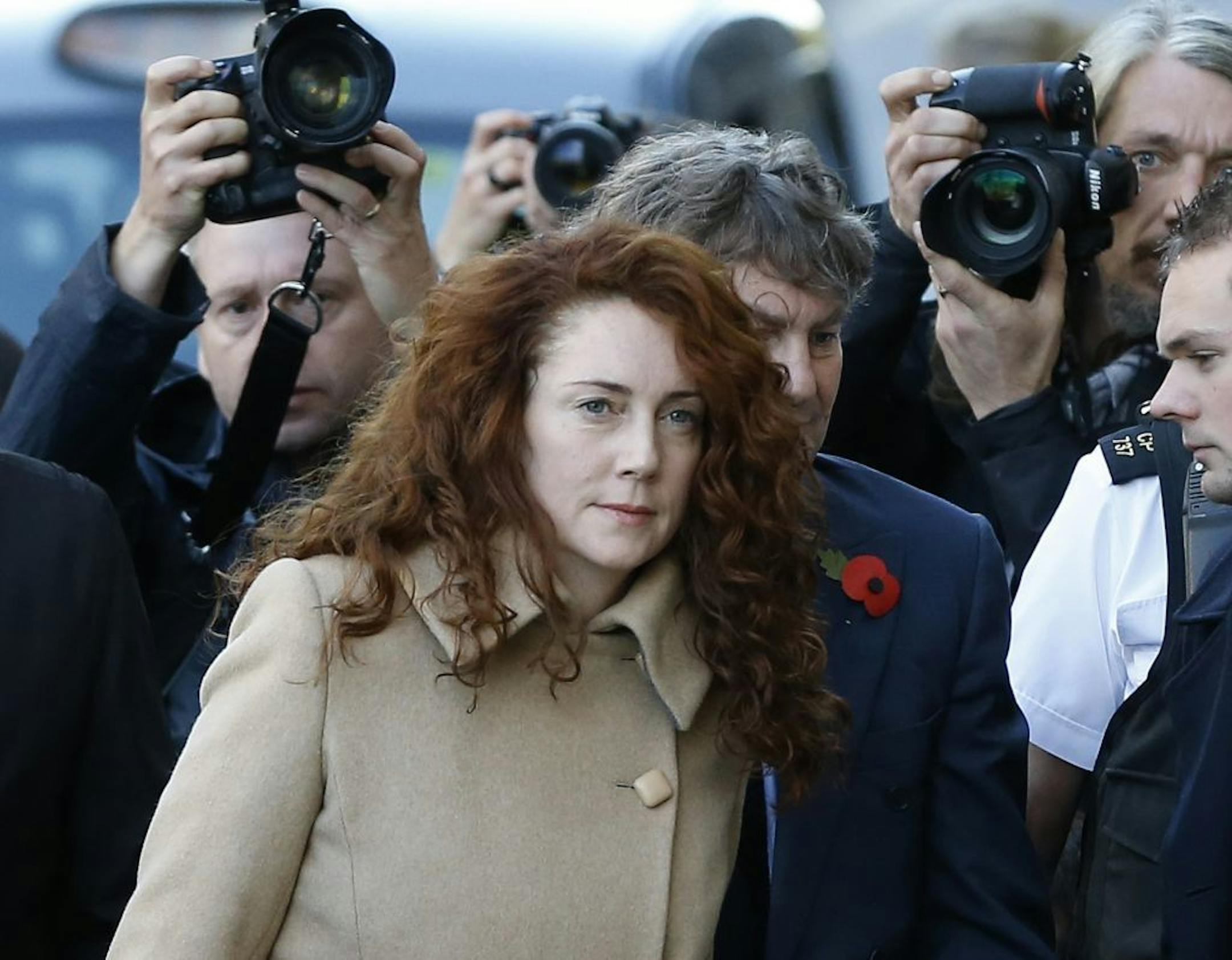 Former newspaper editor Rebekah Brooks and husband Charlie Brooks, obscured behind right, arrive at The Old Bailey law court in London, Monday, Oct. 28, 2013.