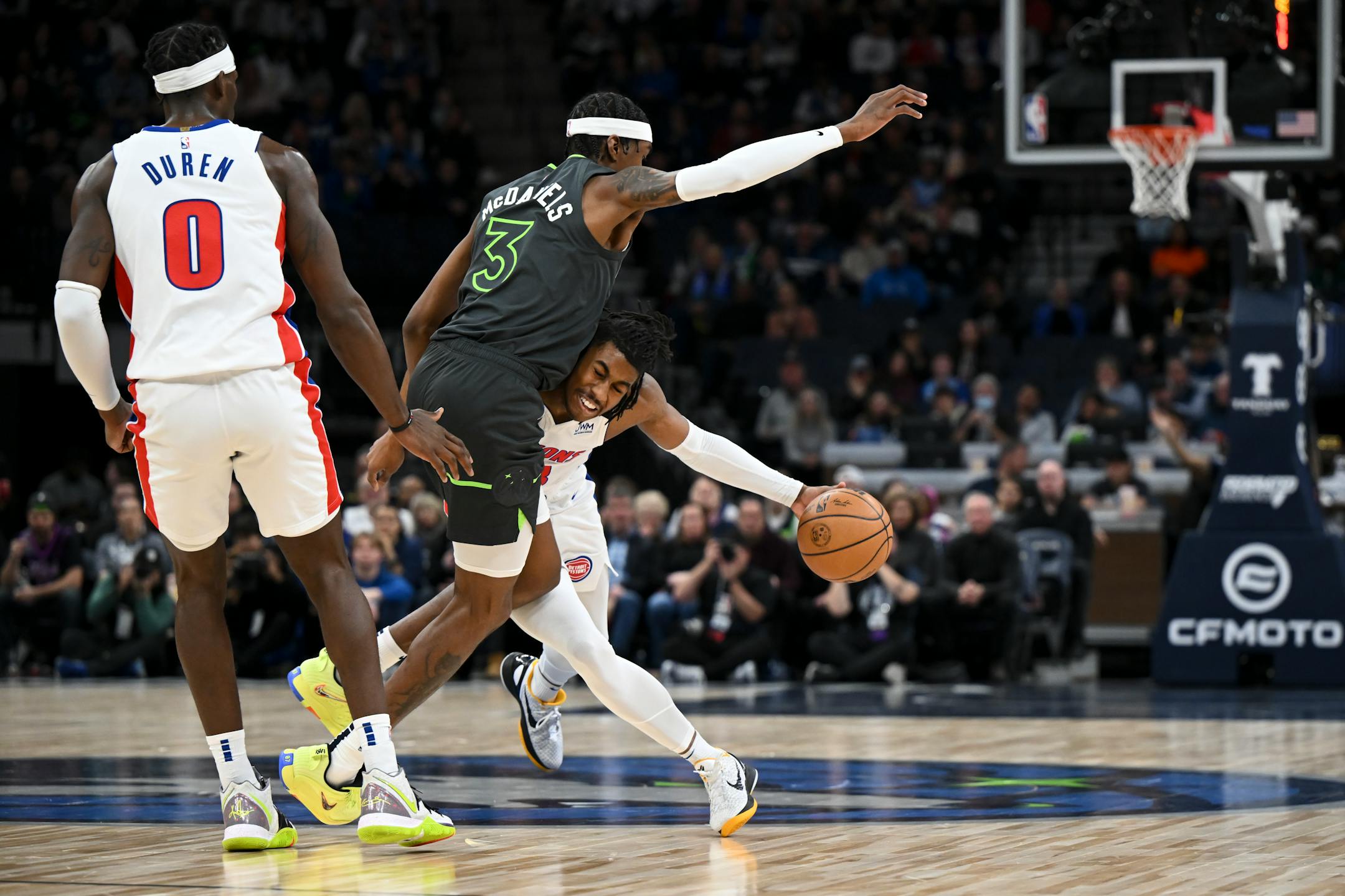 Detroit Pistons guard Jaden Ivey (23) collides with Minnesota Timberwolves forward Jaden McDaniels (3) while driving down the court during the first half.