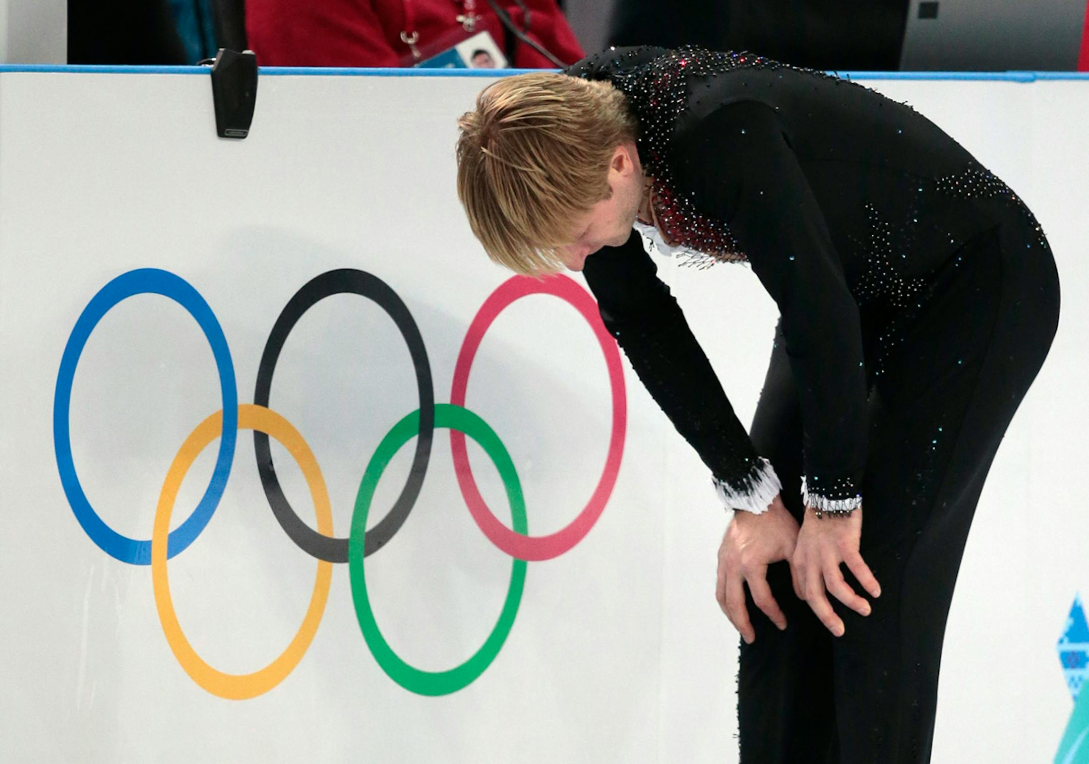 Evgeni Plushenko of Russia skates on the ice prior to pulling out of the men's short program figure skating competition due to illness at the Iceberg Skating Palace during the 2014 Winter Olympics, Thursday, Feb. 13, 2014, in Sochi, Russia. (AP Photo/Ivan Sekretarev)