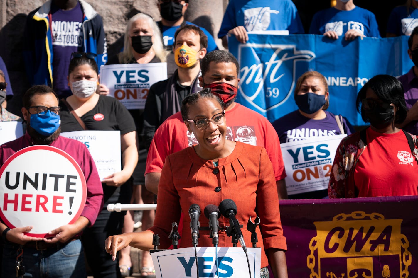 JaNaé Bates, with Yes for Minneapolis, spoke at a podium as she stood with representatives from different unions including the Minneapolis Federation of Teachers, SEIU Local 26, CTUL, Awood Cente Restaurant Opportunities Center (ROC)–MN, CWA Local 7250 who came to support Question 2 on the election ballot, that seeks to change the charter in Minneapolis to allow the creation of a new Department of Public Safety, outside City Hall in Minneapolis, Minn., on Friday, September 10, 2021.