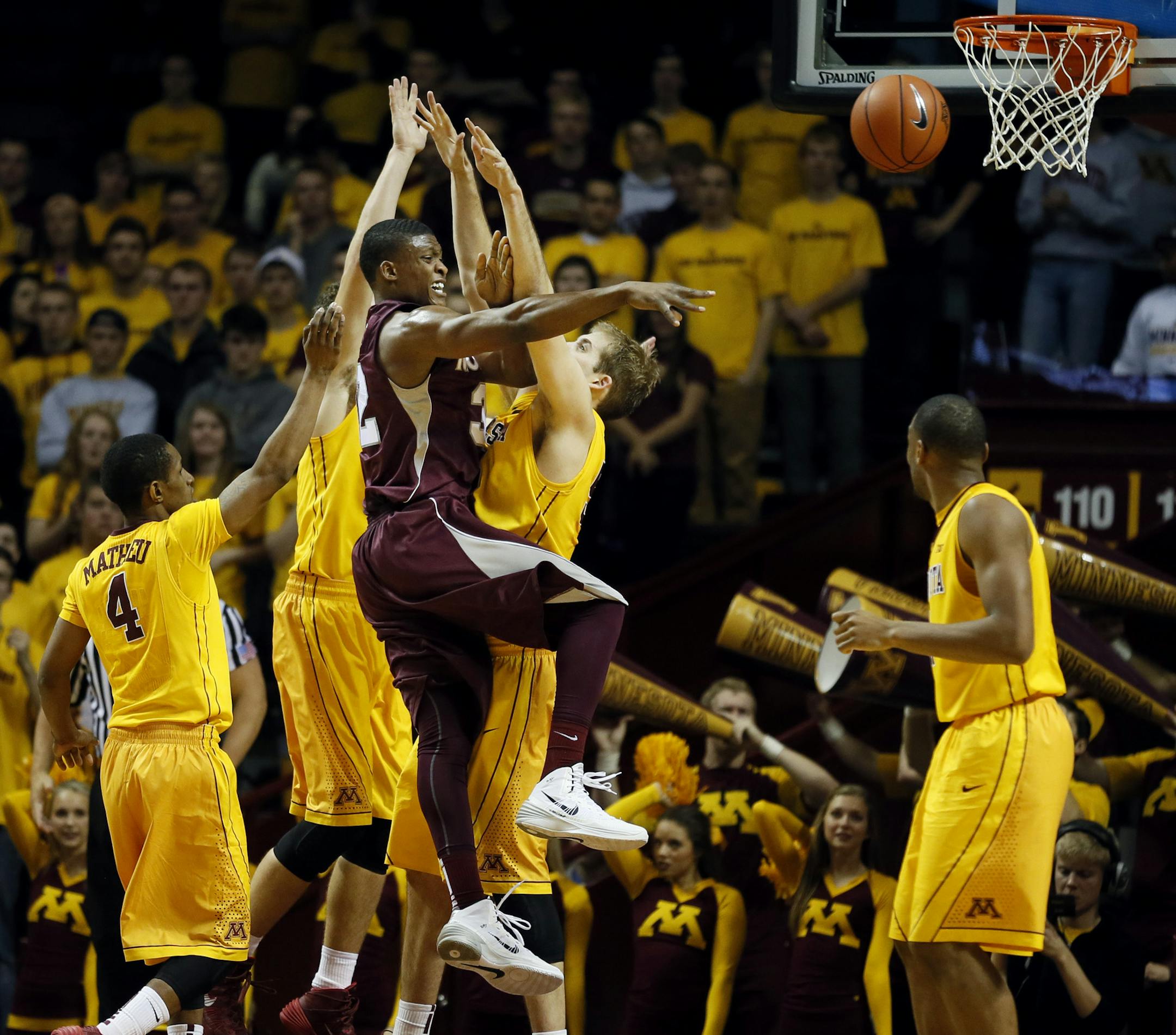 Montana's Kareem Jamar (32) collided with Minnesota's Elliott Eliason (55) during NCAA basketball action between MInnesota and Montana at Williams arena Tuesday November 12, 2013 in Minneapolis , MN. ] JERRY HOLT &#x201a;&#xc4;&#xa2; jerry.holt@startribune.com