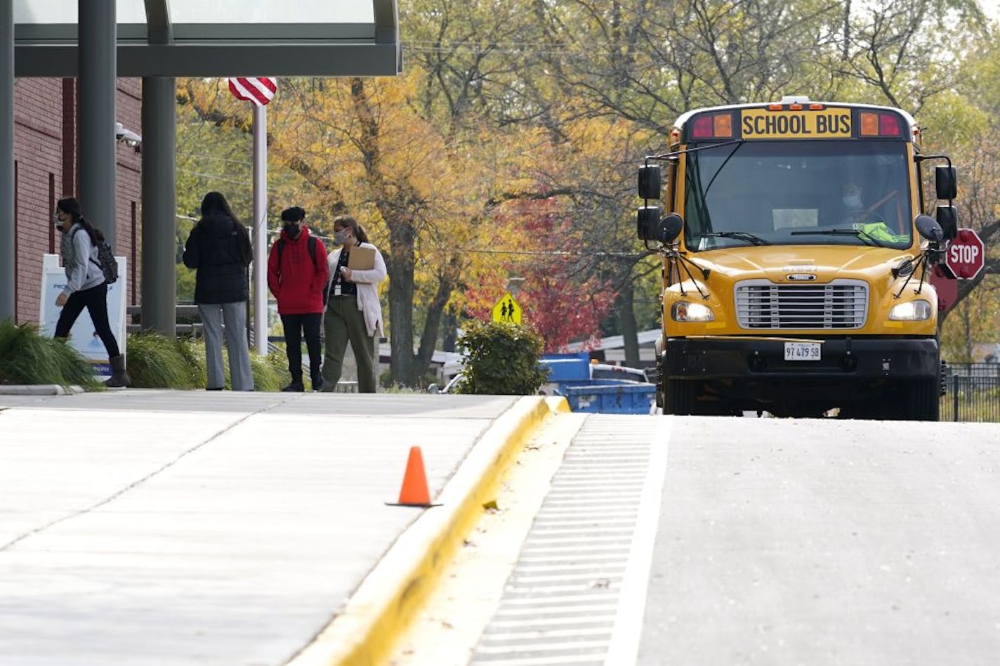 Students wear mask as they arrive their school for in- person learning at Holmes Middle School in Wheeling, Ill., Wednesday, Oct. 21, 2020. Some mental health clinics serving young people in Minnesota aren't seeing the increase in patients that they expected.