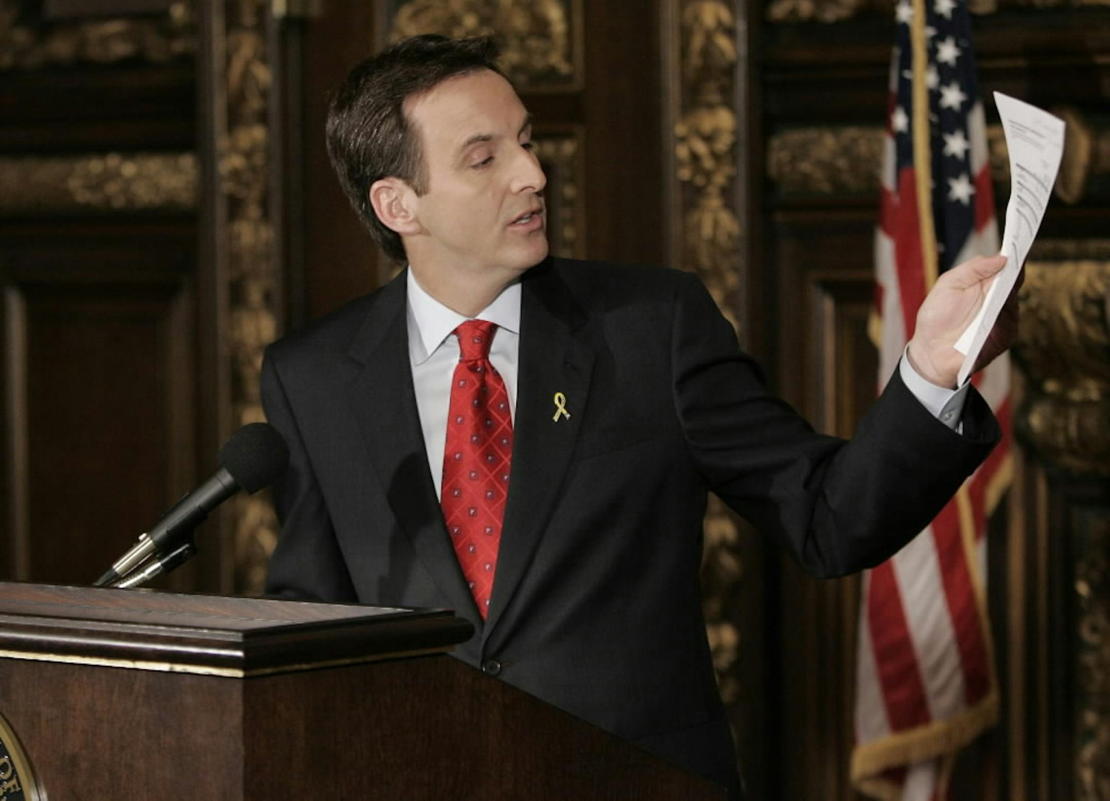 Minnesota Gov. Tim Pawlenty talks about his proposed budget fix Friday during a news conference in St. Paul, where he addressed the need to solve the state's projected $935 million deficit without raising taxes.