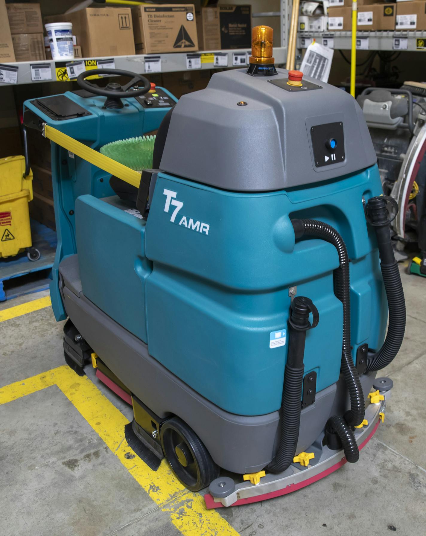 The new automated floor scrubbers at Walmart are kind of like a giant Roomba, replacing the manual push versions seen to the right. They roam the store autonomously, stopping and steering around customers. The upgrades are part of a $36 million investment in new technologies and upgrades to Walmarts in Washington state. (Bettina Hansen / The Seattle Times/TNS)