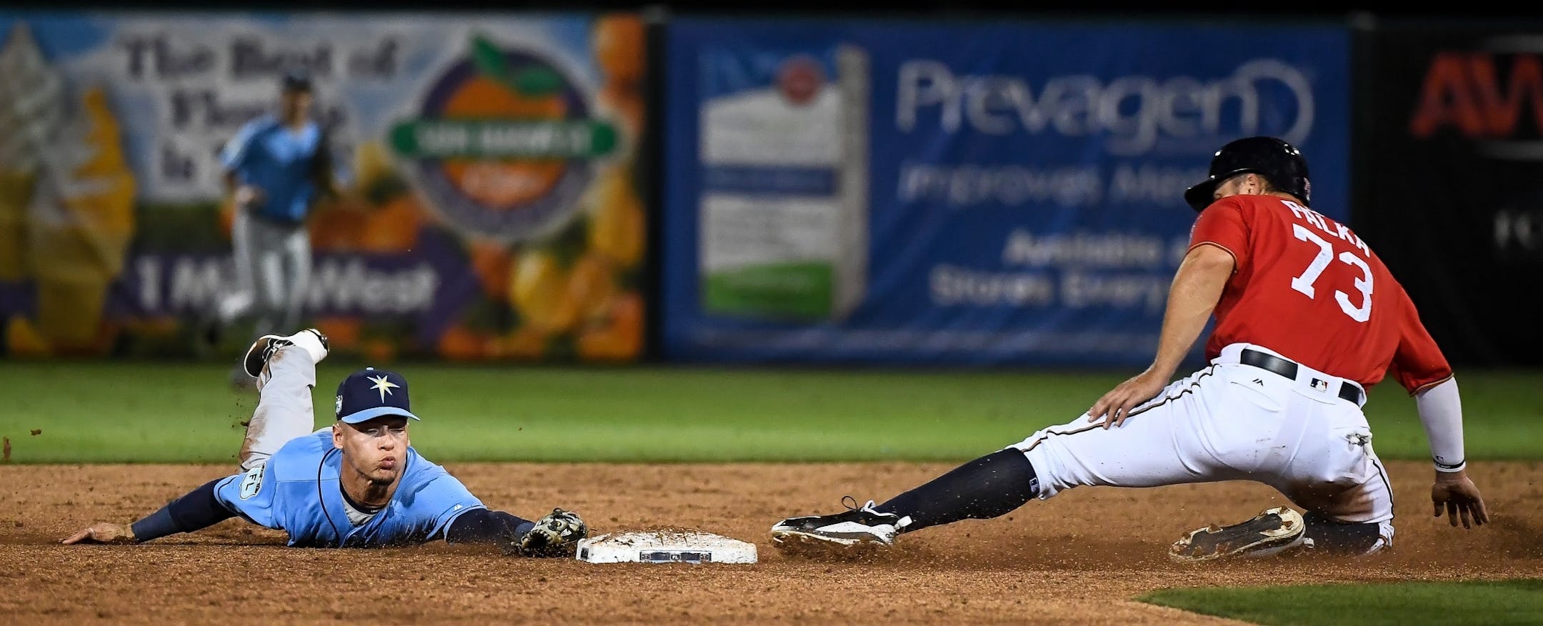 Minnesota Twins outfielder Daniel Palka (73) slides in safely to second off a hit by Matt Hague as Rays shortstop Andrew Velazquez was unable to get the out.