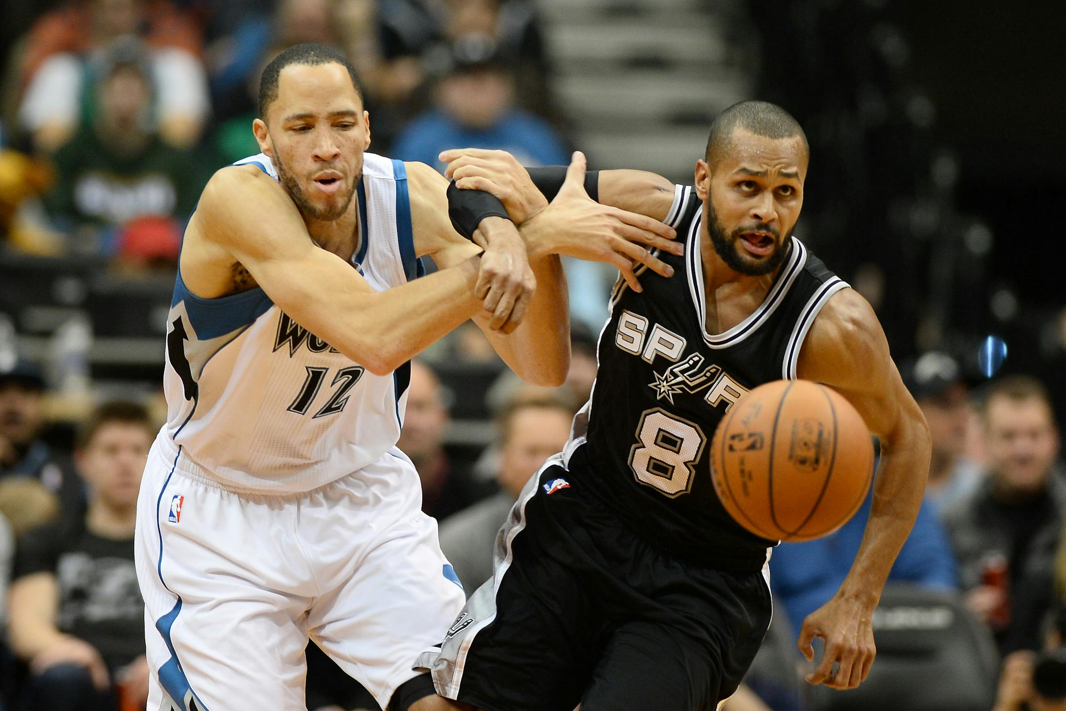 Minnesota Timberwolves forward Tayshaun Prince (12) and San Antonio Spurs guard Patty Mills (8) were tangled up while chasing a loose ball in the second quarter.