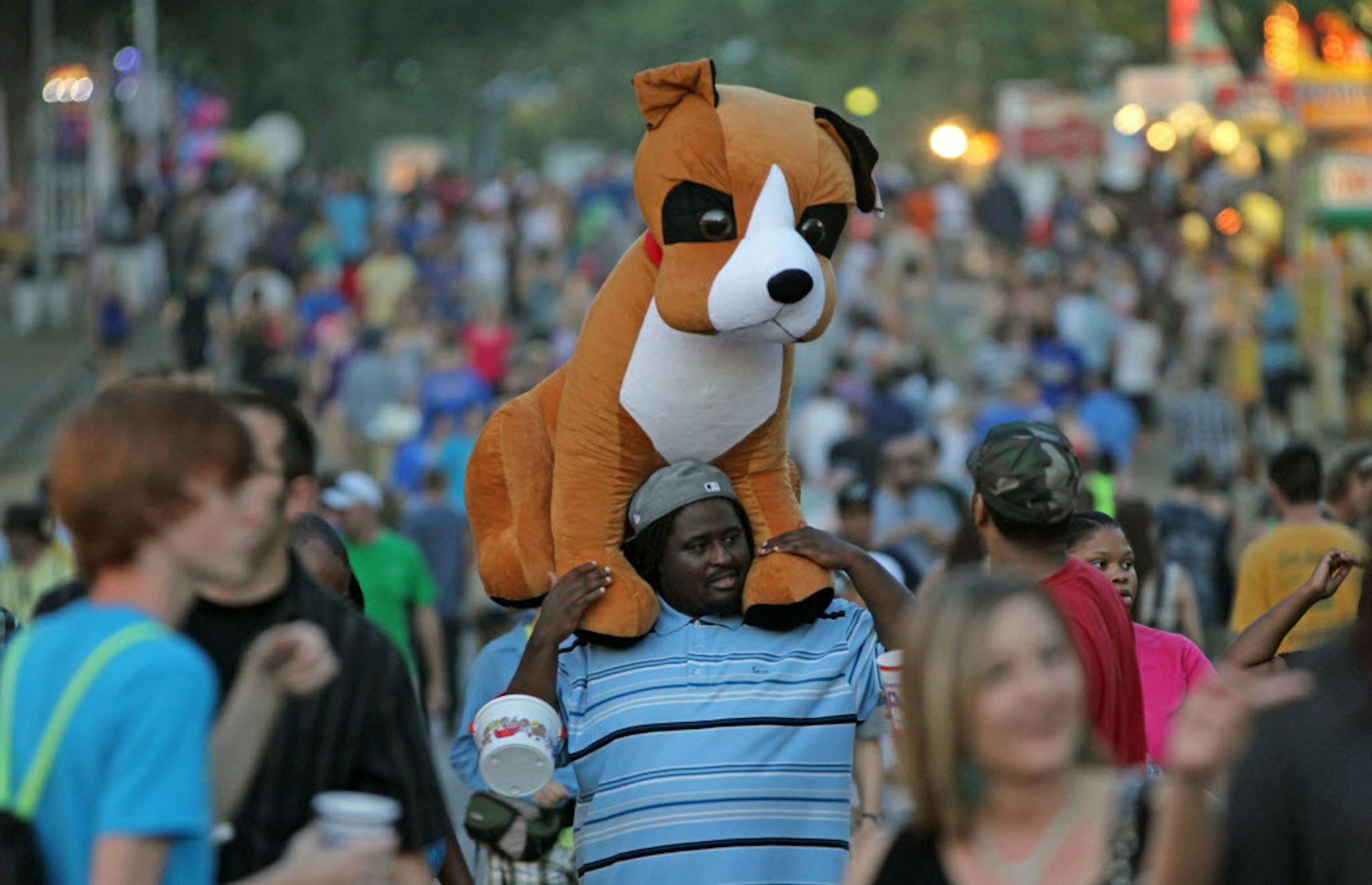 James Williams of New Hope carried his stuffed animal on his shoulders Sunday night as he made his way to the exit at the Minnesota State Fair.