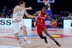 Canada guard Nickeil Alexander-Walker attempts to go around Serbia guard Ognjen Dobric during last year's World Cup semifinals in the Philippines.