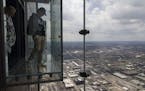 Visitors explore The Ledge glass boxes on the 103rd floor of the remodeled Skydeck on April 21, 2021, at Willis Tower in Chicago.