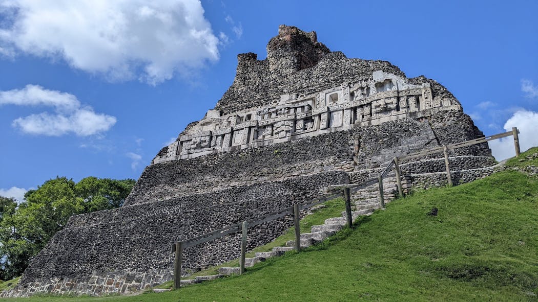 The top of El Castillo, a step pyramid at Xunantunich, features a restored Mayan frieze. 