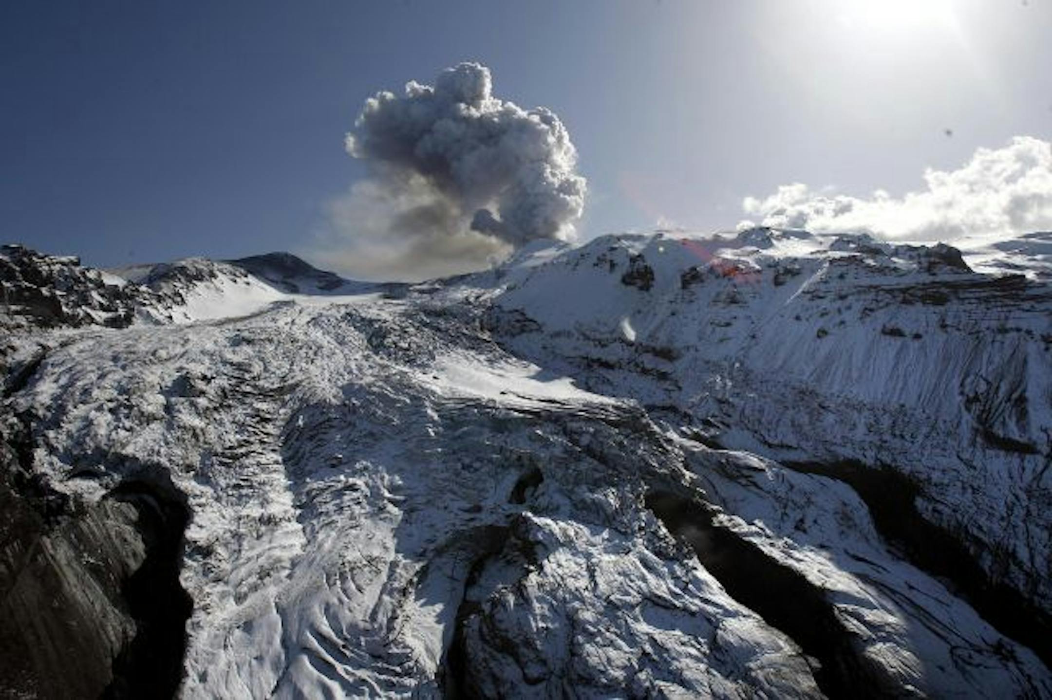 Activity is seen from the volcano in southern Iceland's Eyjafjallajokull glacier, Wednesday, April 21, 2010. Geologists continued to keep a close watch on the Iceland volcano Eyjafjallajokull on Wednesday, as observers noticed a change in the eruption pattern. Instead of thick black smoke, the plume was almost white... and more like steam than black ash.