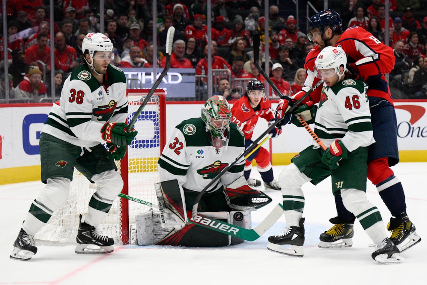 Washington Capitals left wing Alex Ovechkin (8) battles for the puck against Minnesota Wild goaltender Filip Gustavsson (32) on Tuesday.