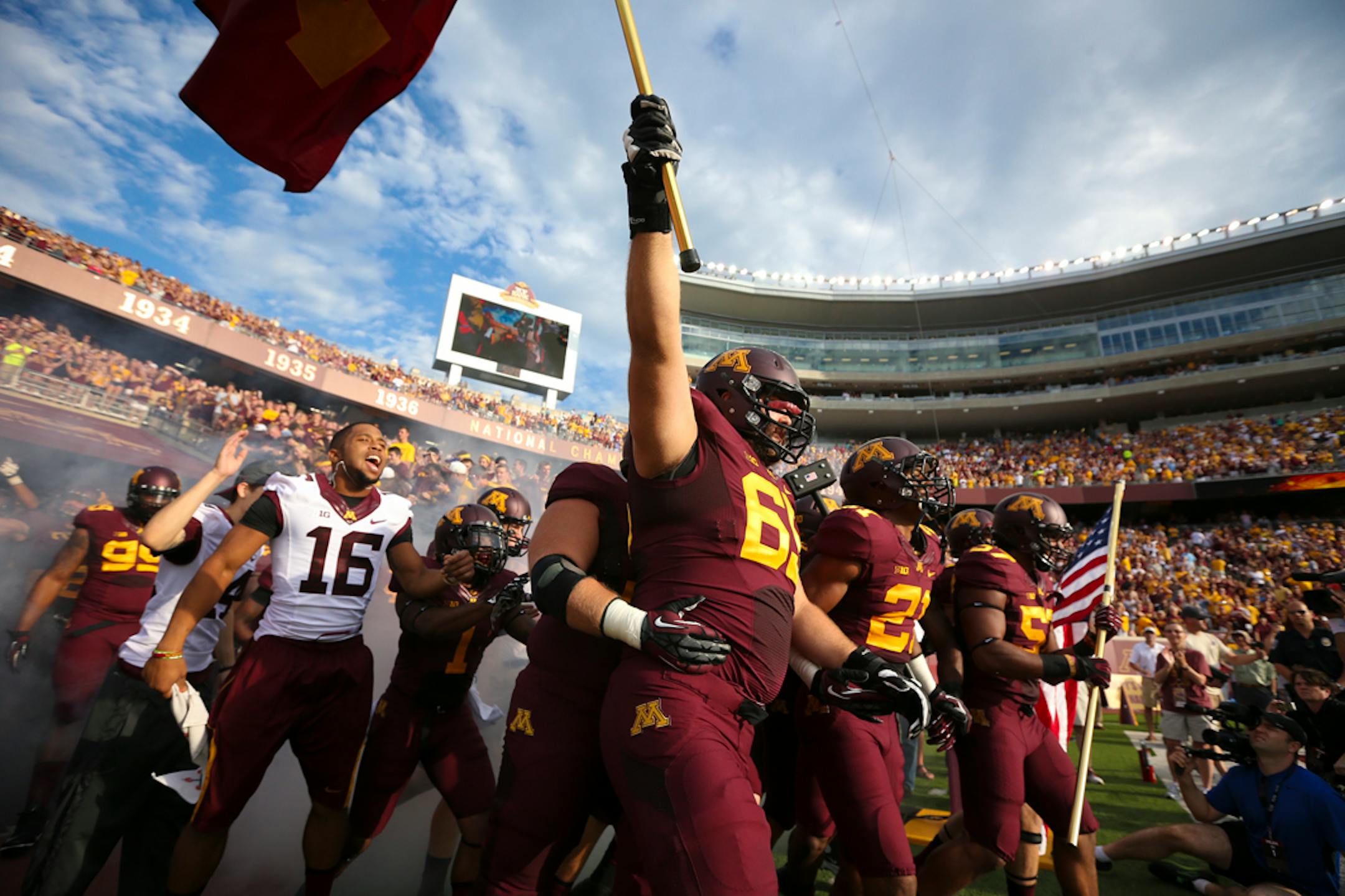 Players walked onto the field before the Minnesota Gophers vs. UNLV in the season opener at TCF Bank Stadium at the University of Minnesota in Minneapolis, Minn.