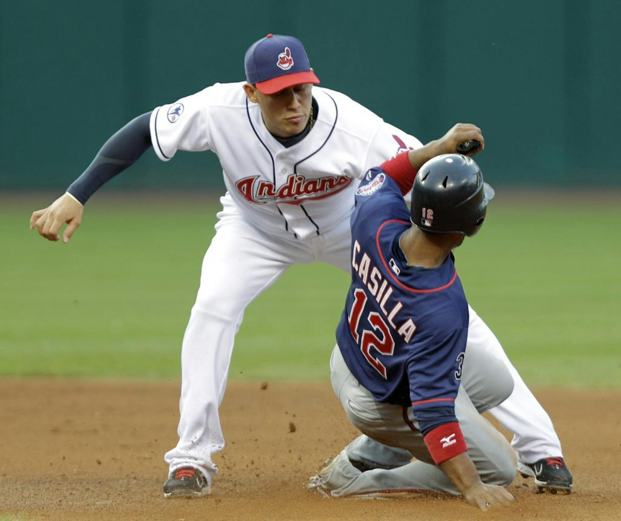 Cleveland Indians shortstop Asdrubal Cabrera, left, tags out Minnesota Twins' Alexi Casilla (12) on an attempt to steal second base in the fourth inning of a baseball game Friday, Aug. 12, 2011, in Cleveland.