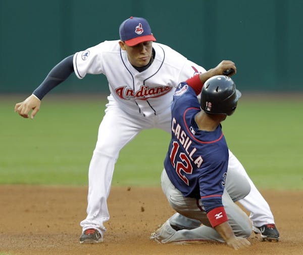 Cleveland Indians shortstop Asdrubal Cabrera, left, tags out Minnesota Twins' Alexi Casilla (12) on an attempt to steal second base in the fourth inni