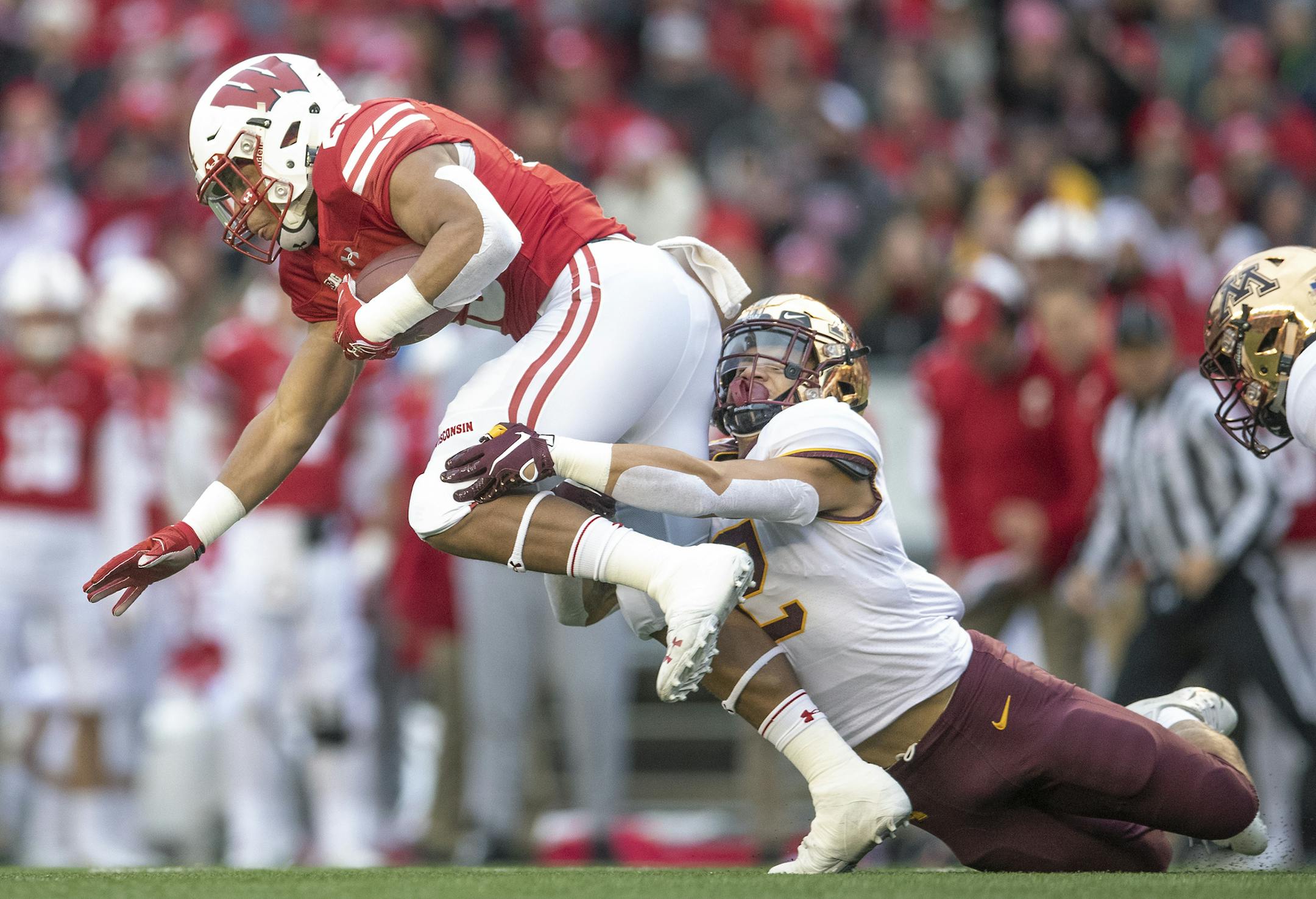 Minnesota's defensive back Jacob Huff brought down Wisconsin's running back Jonathan Taylor during the first quarter as Minnesota took on Wisconsin at Camp Randall Stadium, Saturday, November 24, 2018 in Madison, Wis. ] ELIZABETH FLORES • liz.flores@startribune.com