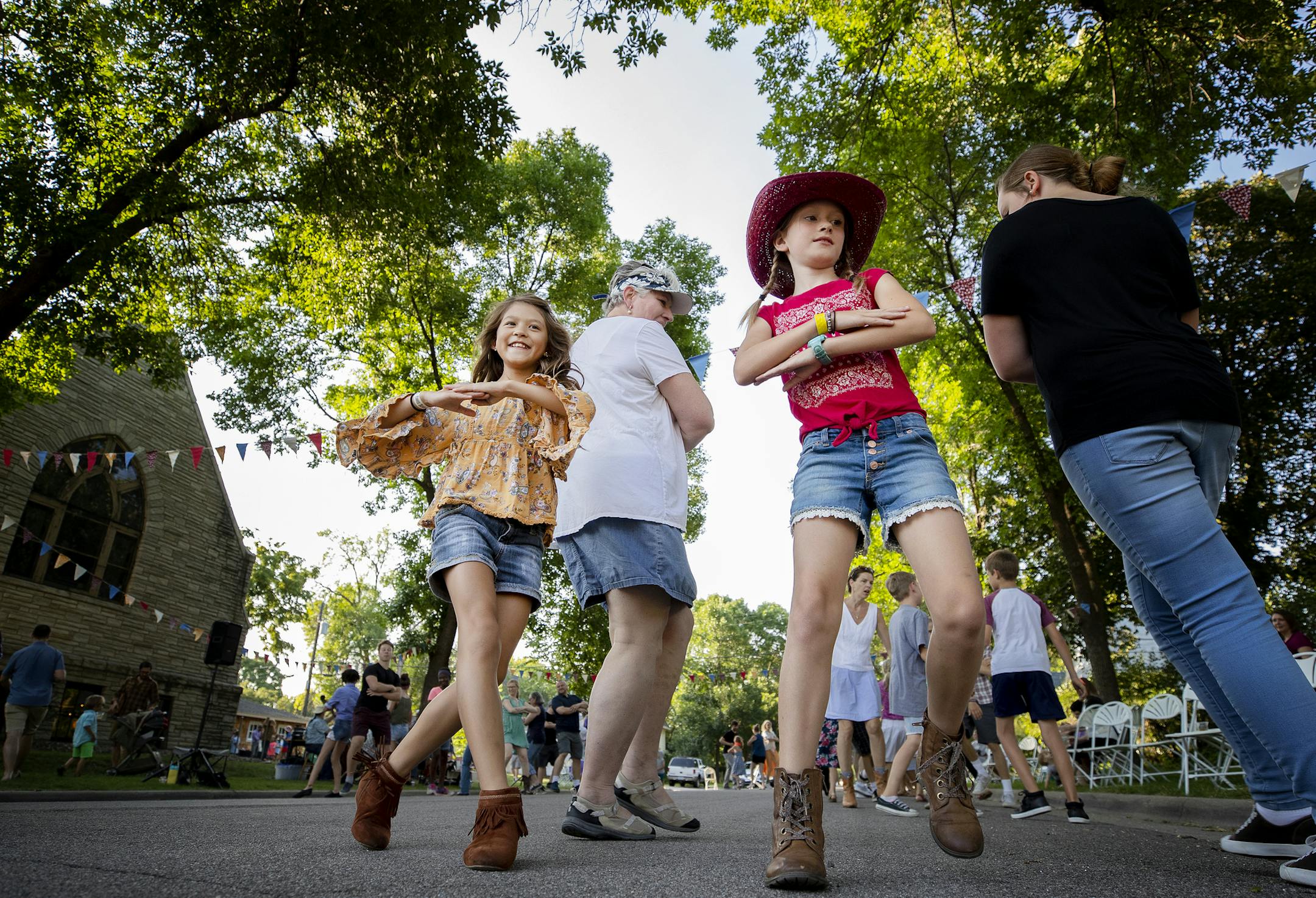 Kathryn Lockrem, 10, and Ruby Groves, 11, square danced to music by Eelpout Stringers at the Art House North in St. Paul. ] CARLOS GONZALEZ ï cgonzalez@startribune.com ñ July 24, 2018, St. Paul, MN, Square dance with Eelpout Stringers at the Art House North.
