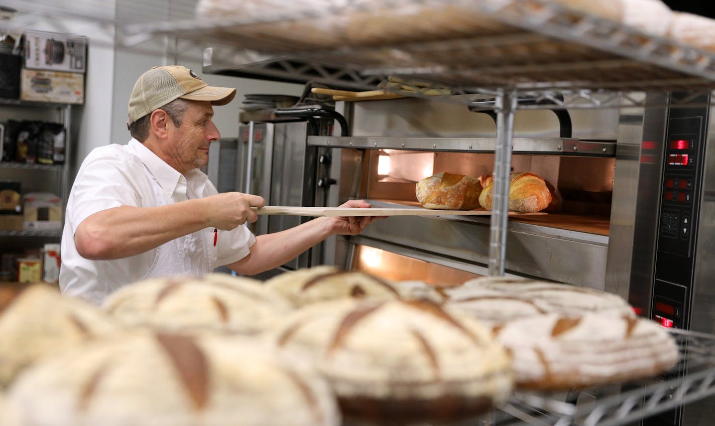 Baker Joachim Berndt pulled a pair of bread loaves from the oven Saturday morning. ] ANTHONY SOUFFLE &#x2022; anthony.souffle@startribune.com Joachim Berndt baked bread Saturday, Jan. 28, 2017 at his bakery in northeast Minneapolis. Berndt immigrated to Minnesota from Germany 17 years ago and, unable to find German-style breads from his homeland, he started baking, selling loaves to farmers markets in Maple Grove, Osseo, Minnetonka and Hopkins. By 2014, he had grown business enough to open his o