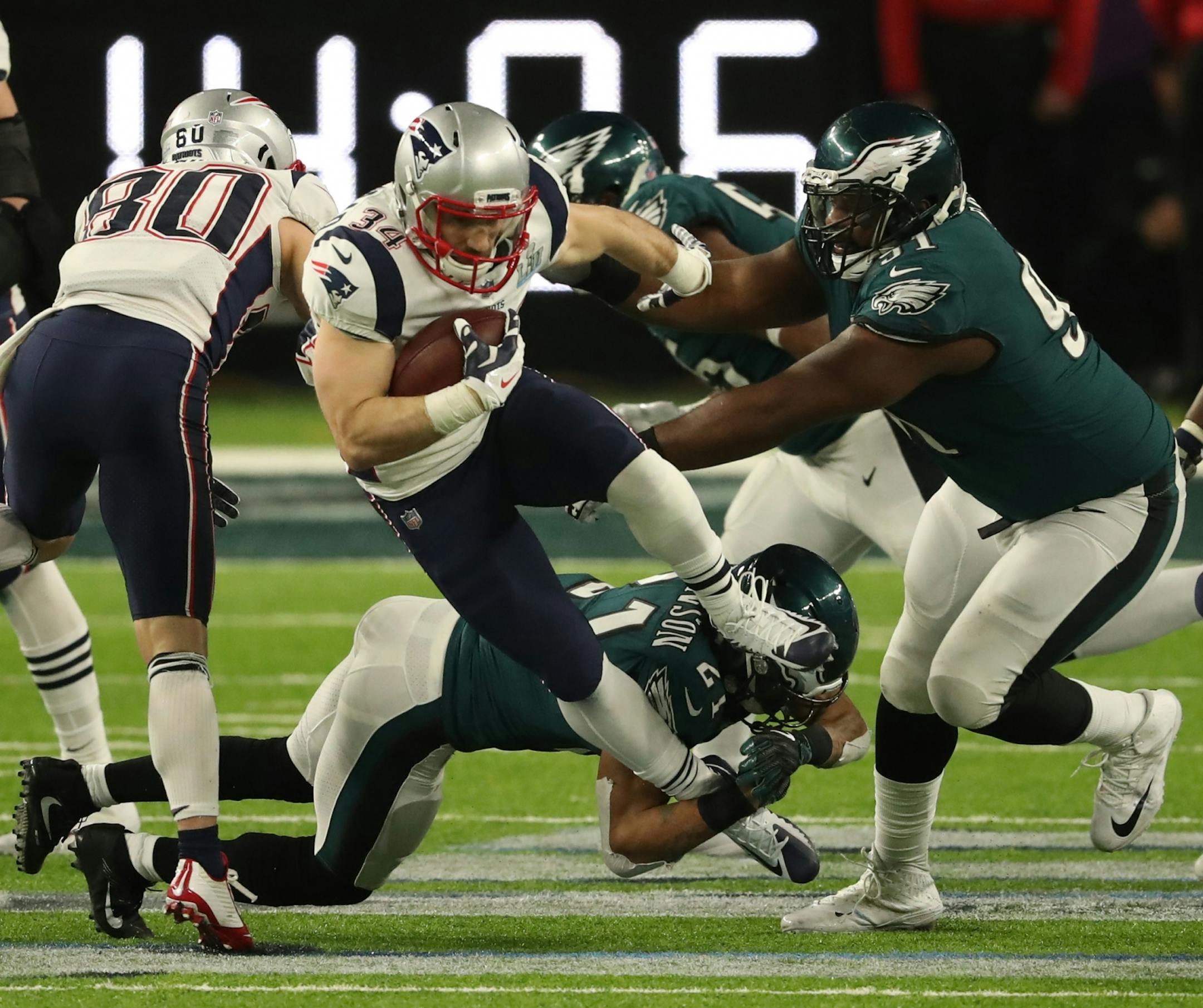 New England Patriots running back Rex Burkhead (34) ran through a tackle in the fourth quarter of Super Bowl LII.