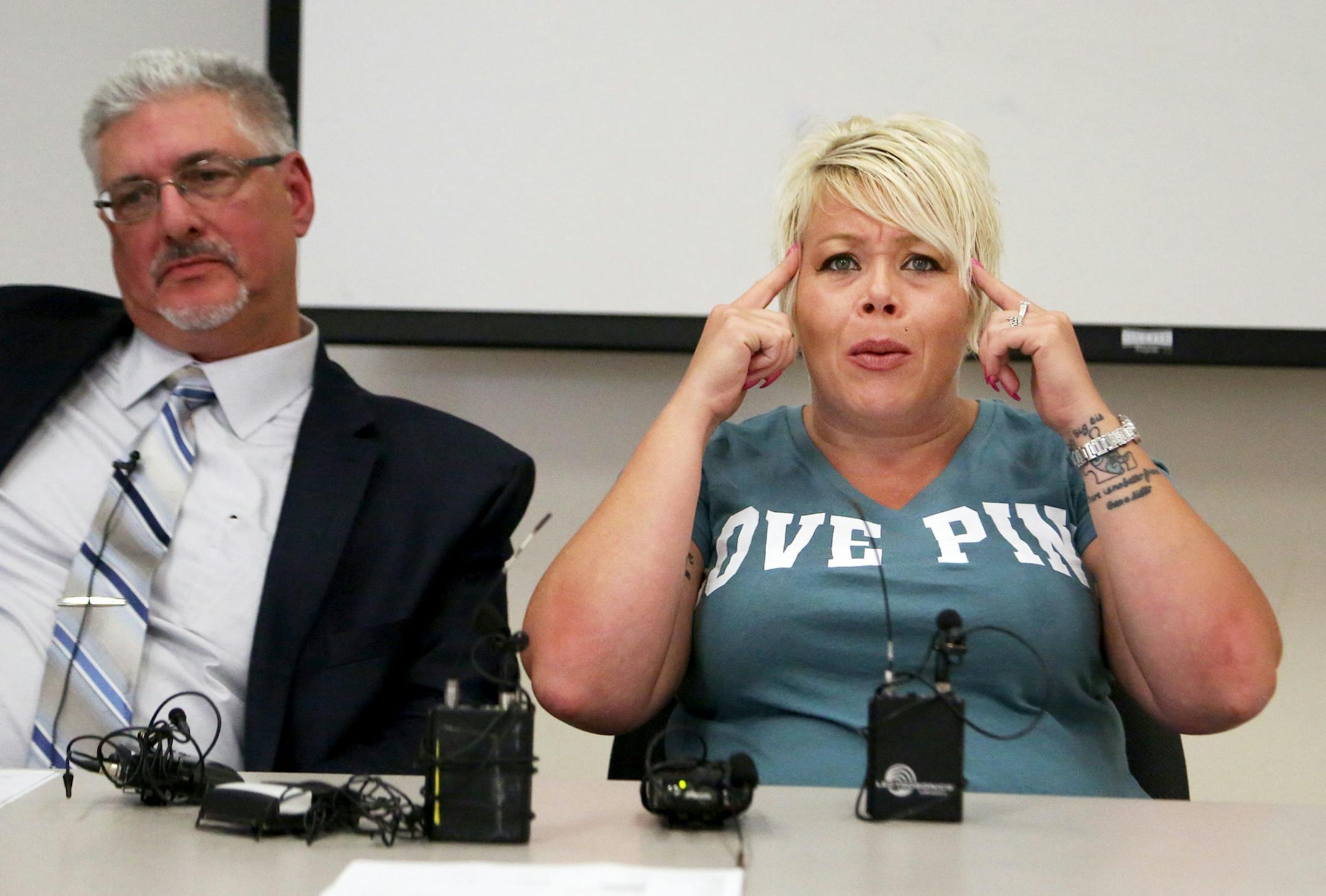 During a press conference about police body cam video released that shows dogs being shot by a Minneapolis police officer, the dogs owner Jennifer LeMay expresses her anger with the Minneapolis police about the incident with her attorney Mike Padden, left, seated nearby at the Minneapolis Urban League Wednesday, July 19, 2017, in Minneapolis, MN.