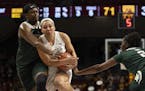 Minnesota Golden Gophers guard Destiny Pitts (3) is wrapped up by Michigan State Spartans forward Nia Hollie (12) as she tries to drive around her and