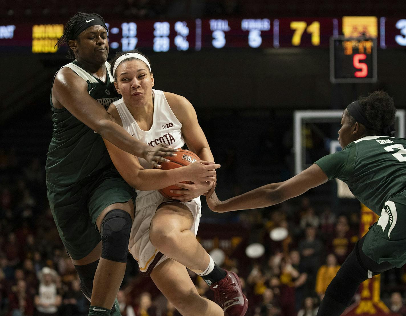 Minnesota Golden Gophers guard Destiny Pitts (3) is wrapped up by Michigan State Spartans forward Nia Hollie (12) as she tries to drive around her and past Michigan State Spartans forward Mardrekia Cook (2) in the fourth quarter on Sunday, March 3, 2019 at Williams Arena in Minneapolis, Minn. Pitts led the Gophers with 26 points. (Jeff Wheeler/Minneapolis Star Tribune/TNS) ORG XMIT: 1276611