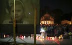 Mourners stood with their lit candles during the prayer vigil for Alayna Ertl on Tuesday night in the parking lot of St. Anthony Church in Watkins, Mi