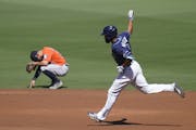 Tampa Bay Rays Manuel Margot rounds the bases past Houston Astros' Jose Altuve after hitting a three run home run against Houston Astros starting pitc