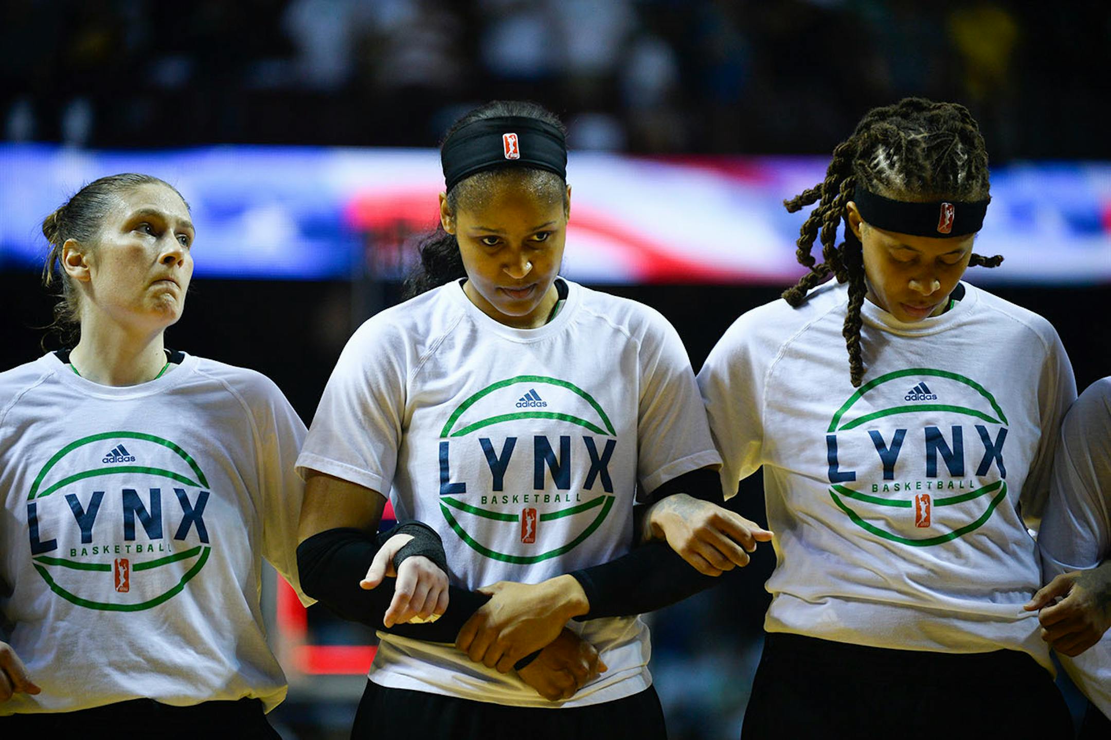 Minnesota Lynx players including Lindsay Whalen, Maya Moore and Seimone Augustus (33) linked arms during the National Anthem Sunday.
