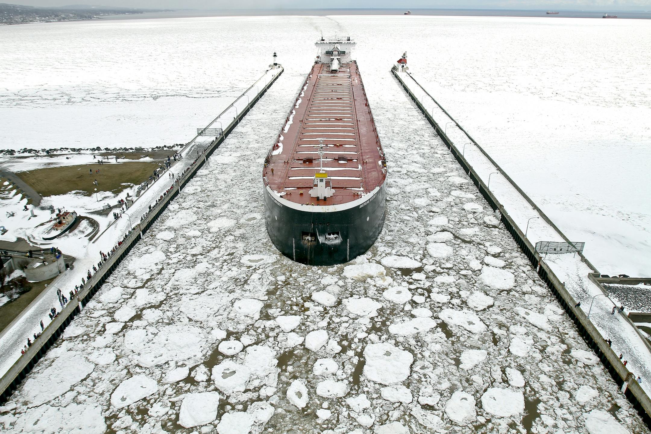 The American Integrity enters the Duluth ship canal after ice on Lake Superior blocked access to the Duluth Superior harbor in Duluth, Minn. Saturday April 14, 2013 causing nine ships to wait at anchor in the open lake until ice breaking operations could open a lane for the traffic. The American Integrity was the second of the nine ships come into the Duluth Ship canal.