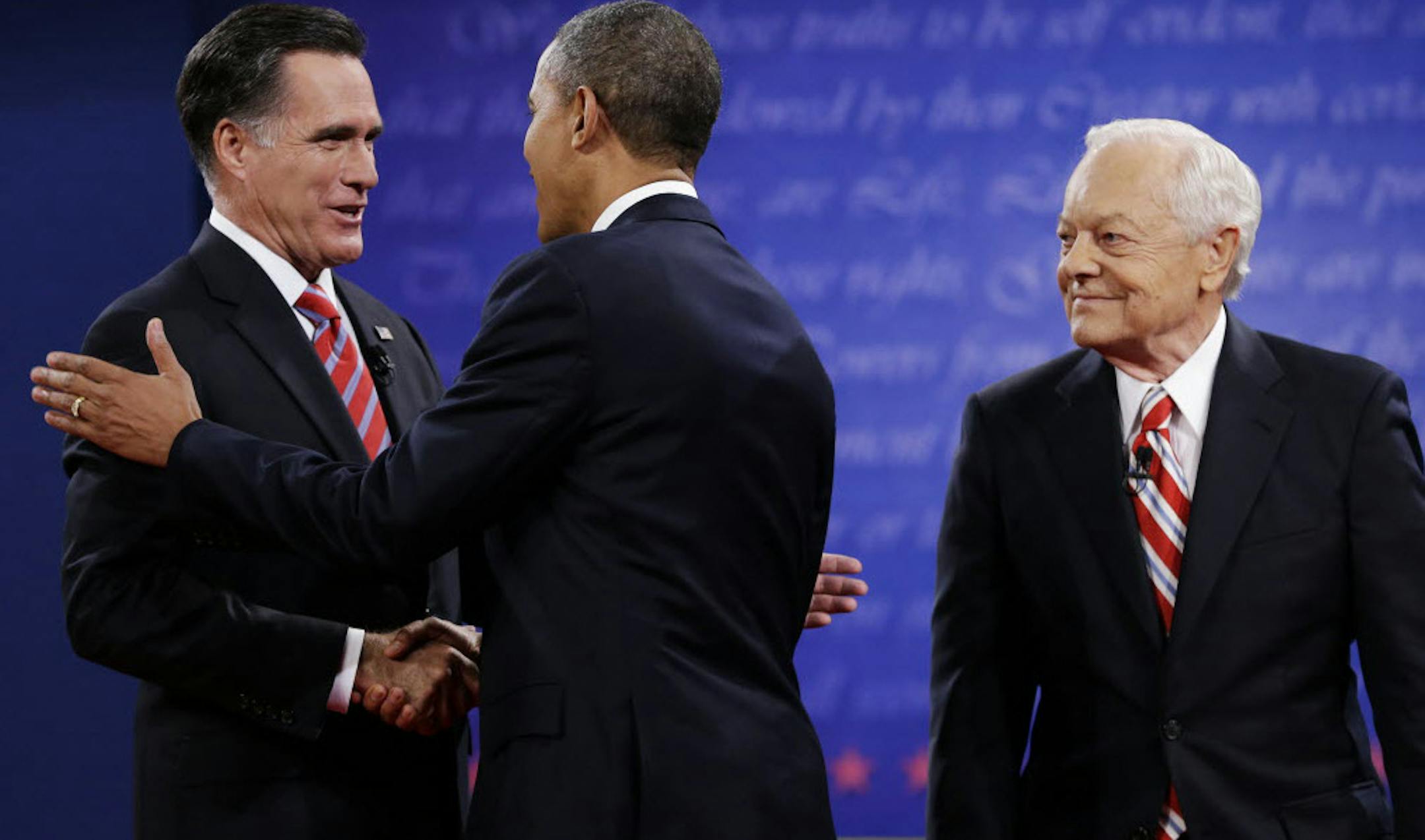 Moderator Bob Schieffer, right, watches as President Barack Obama, center, shakes hands with Republican presidential nominee Mitt Romney before the third presidential debate.