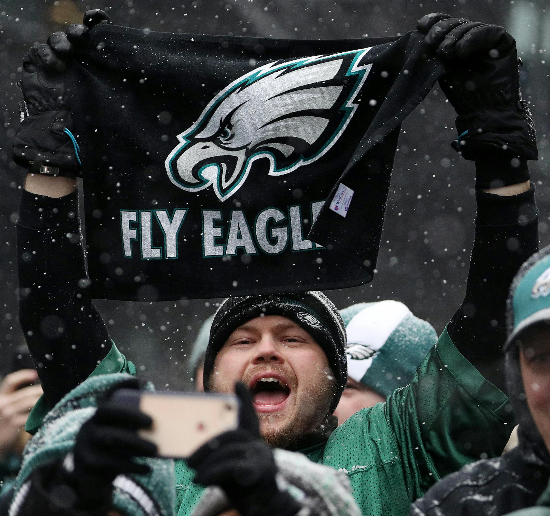 A Philadelphia Eagles fan held up a flag as he cheered during the Eagles rally on Nicollet Mall Saturday. ] ANTHONY SOUFFLE &#xef; anthony.souffle@startribune.com Super Bowl Live attendees took part in Saturday's festivities including an Eagles and Patriots rally as well as the Polaris UpsideDown stunt where Levi LaValle leapt a snowmobile over Nicollet Mall Saturday, Feb. 3, in downtown Minneapolis.