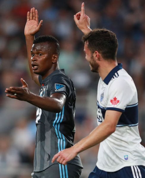 Minnesota United forward Darwin Quintero (25) asked the referee for a handball call in the box while Vancouver Whitecaps midfielder Russell Teibert (3