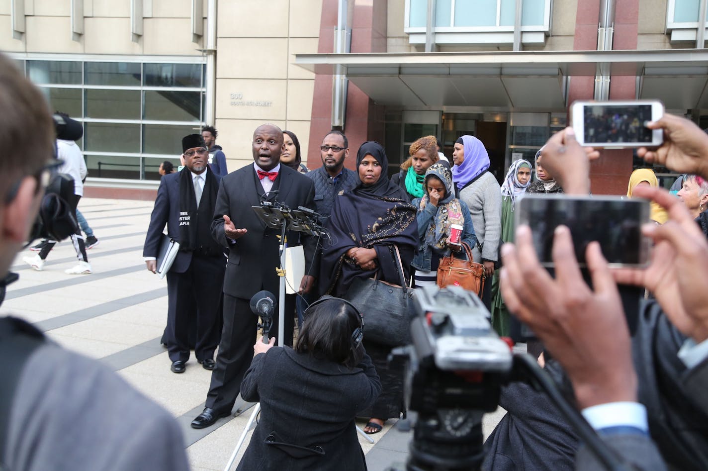 Adnan Farah, the younger of two brothers caught up in Minnesota's ISIL recruiting investigation, was given 10 years in prison Tuesday afternoon in Minneapolis.. Here, family attorney Kenneth Udoibok, middle at microphone, spoke to media members afterward.