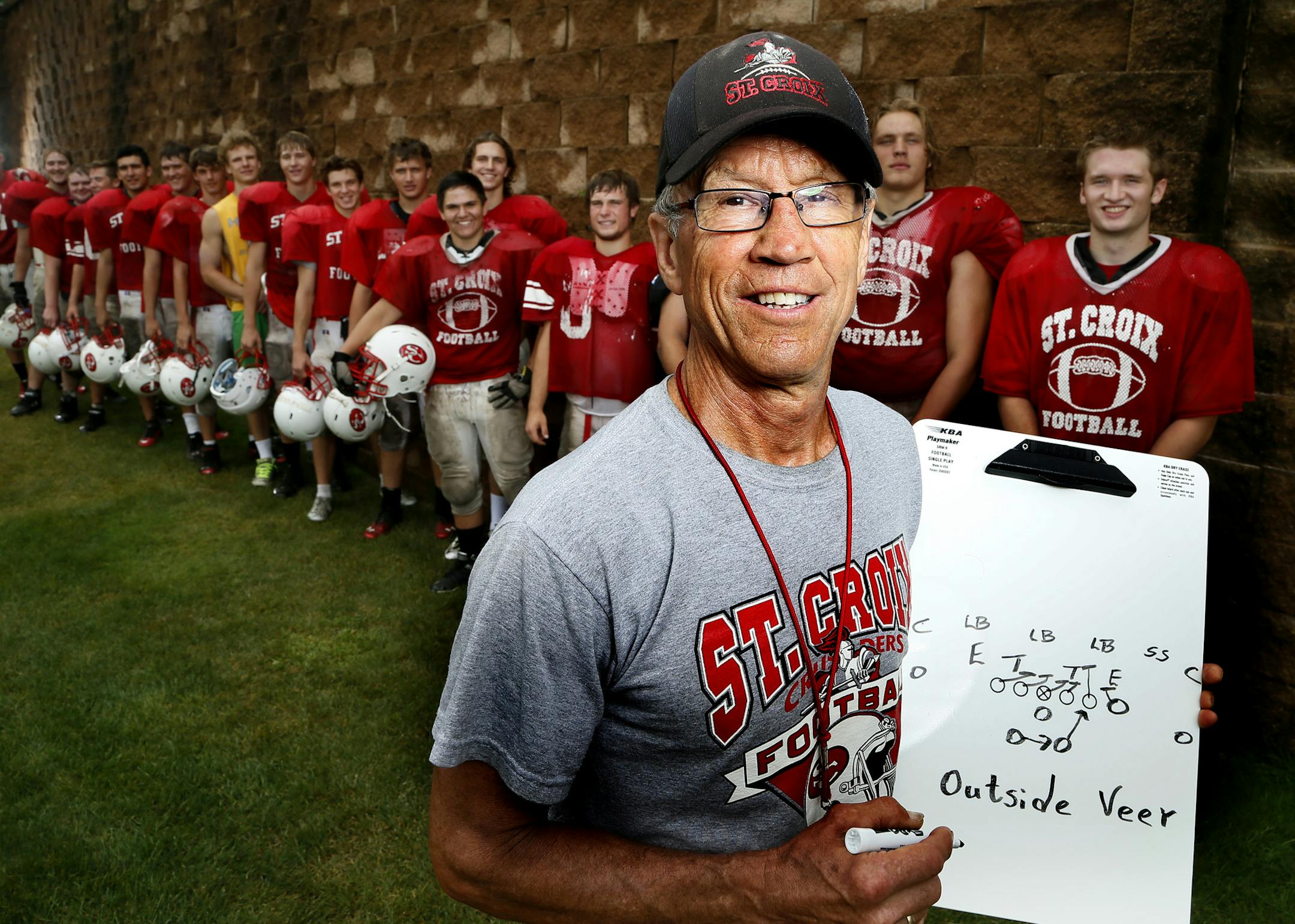 St. Croix Lutheran head football coach Carl Lemke posed for a photo with members of his football team Monday August 18 , 2014 in West St. Paul,MN .] Jerry Holt Jerry.holt@startribune.com