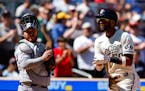 The Minnesota Twins' Willi Castro (50) celebrates his solo home run as he crosses home plate with Toronto Blue Jays catcher Alejandro Kirk looking on 