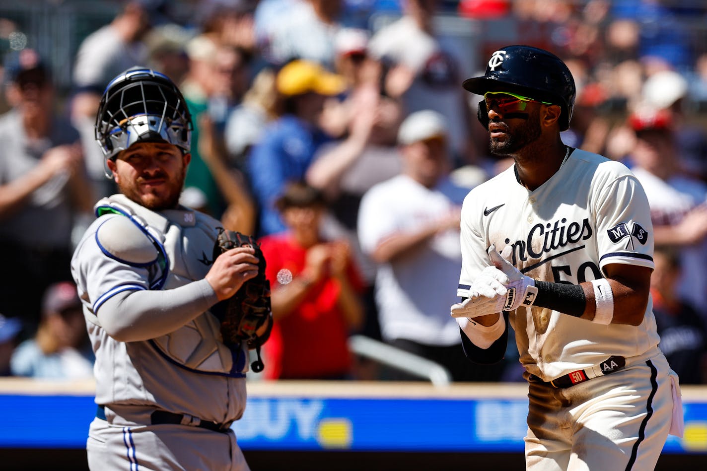 The Minnesota Twins' Willi Castro (50) celebrates his solo home run as he crosses home plate with Toronto Blue Jays catcher Alejandro Kirk looking on in the seventh inning at Target Field on Saturday, May 27, 2023, in Minneapolis. (David Berding/Getty Images/TNS) ORG XMIT: 80539109W