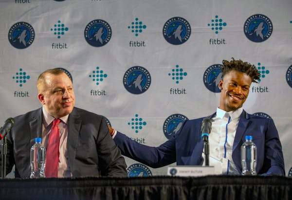 Timberwolves new point guard Jimmy Butler, right, pats coach Tom Thibodeau on the back during a news conference to welcome Butler to the team in June.
