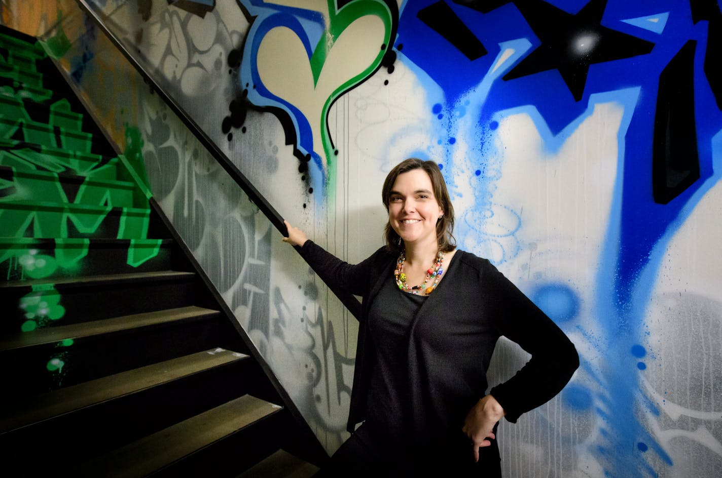 Jen Ford Reedy, the president of the Bush Foundation. The artwork behind her was done by Bush Fellow Peyton Scott Russell called &#x201c;Graffiti at Bush 2015.&#x201d;